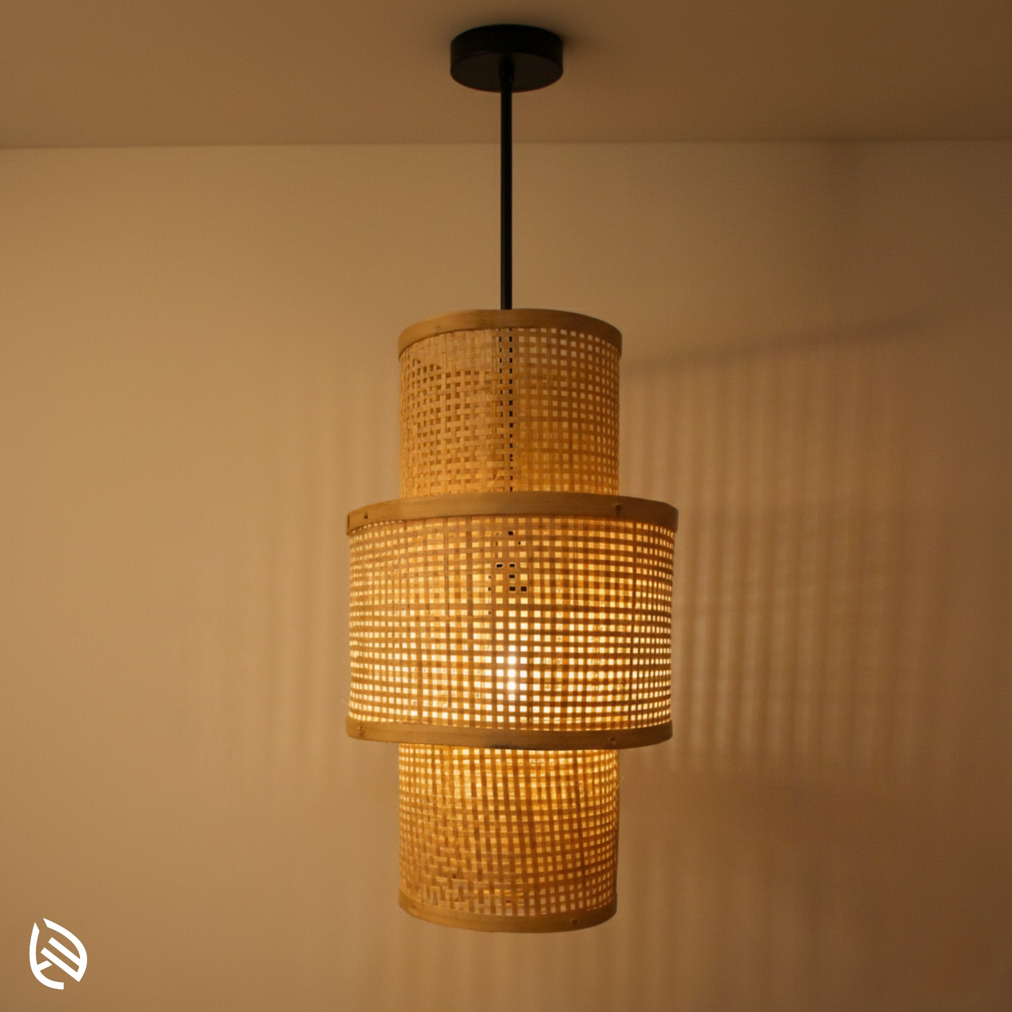 Artisan Aura stacked lantern bamboo pendant glowing; micro-grid cane drums cast linear wall shadows.
