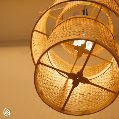 Underside detail: bamboo cross stays and E27 bulb inside stacked cane drums of Artisan Aura pendant.