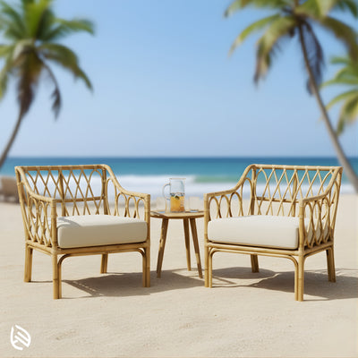 Pair of rattan bistro chairs on beach with side table
