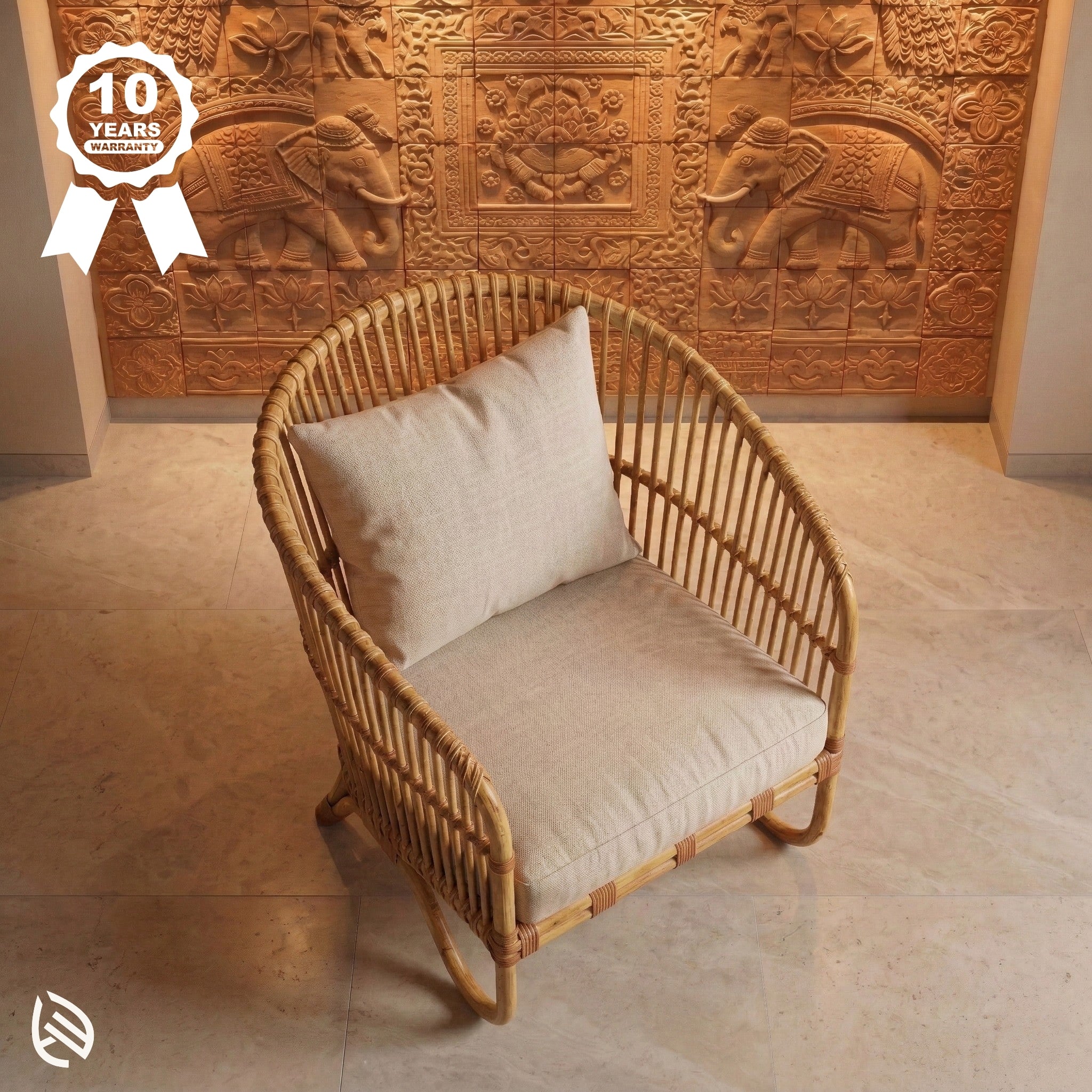 Wicker chair with beige cushion in front of a decorative wall with elephant carvings.