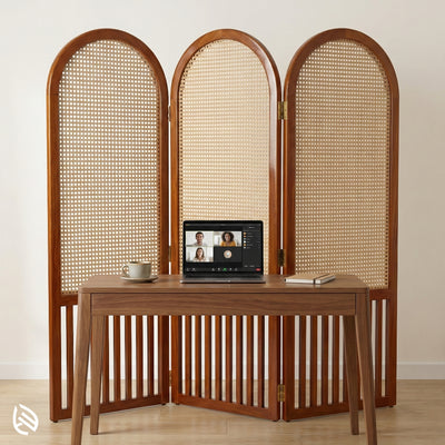 Wooden screen with woven design behind a wooden desk with a laptop.