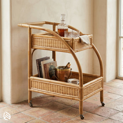 Wicker bar cart with items on a tiled floor