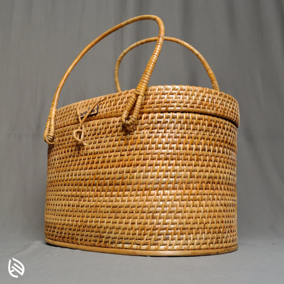 Side angle of Borough rattan basket with lid and dual arch handles on grey background