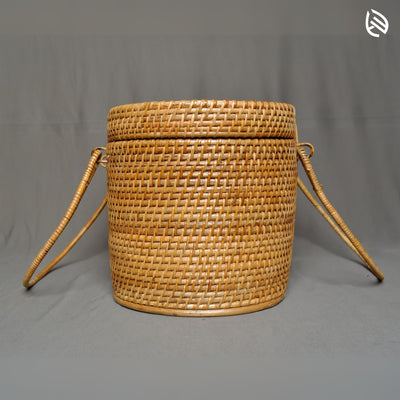 Side view of Borough basket with lid closed and handles resting on either side