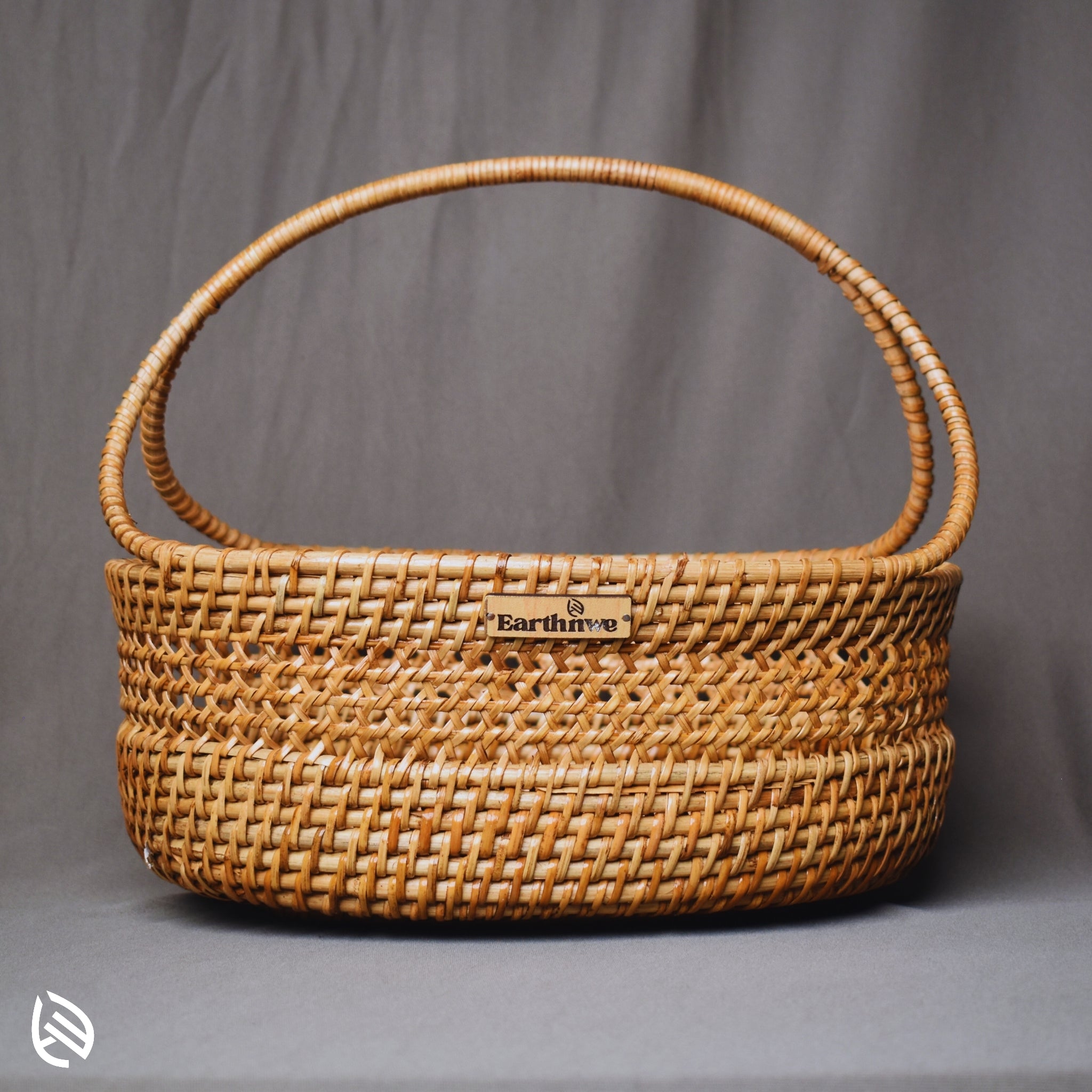 Front view of Clutter Keeper rattan basket with wide base and loop handle