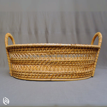 Front view of Drift Stash oval rattan basket with dual loop handles