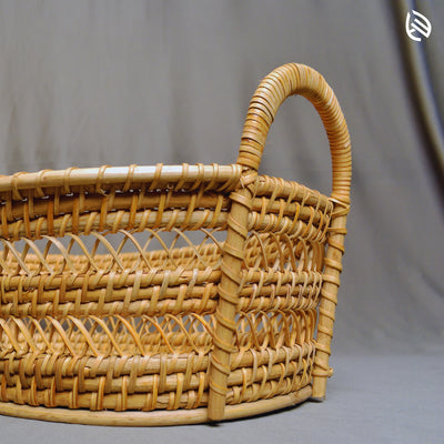 Close-up of Drift Stash dual loop handle and intricate handwoven rattan texture