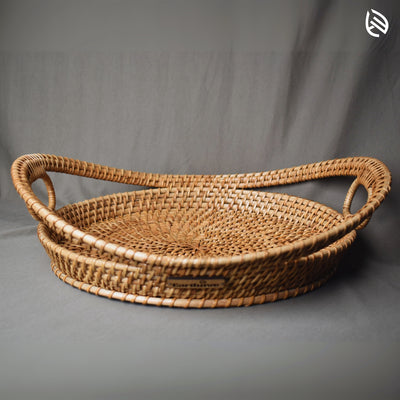 Full view of EarthNwe Harvest Hold tray showing curved twin handles and handwoven circular base