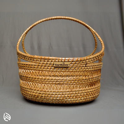 Front view of Tidy Trove wide curved handle rattan basket with EarthNWe branding