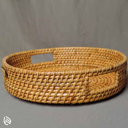 Whisper Weave handwoven round rattan tray with deep frame and cut-out handles on grey background