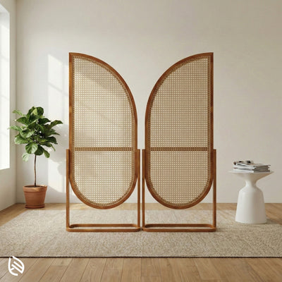 Woven room divider in a modern interior setting with a plant and small table.