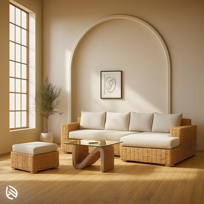 L Shaped Rattan Sofa Set in natural rattan with cream cushions and glass coffee table in a modern neutral living room.