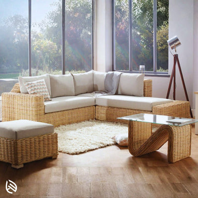 Natural rattan L-shaped sectional sofa with beige cushions styled by a large window - cozy indoor living setup.