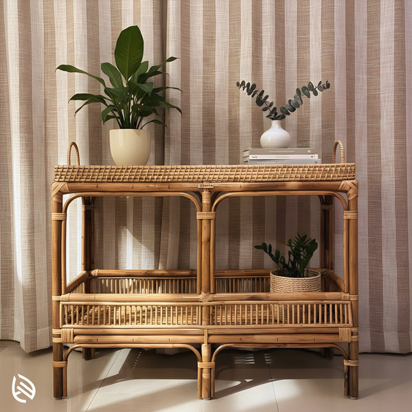 Natural rattan console table styled with plants and books - close view of the Multi-Purpose Marvel two-tier design with woven tray top and side handles.
