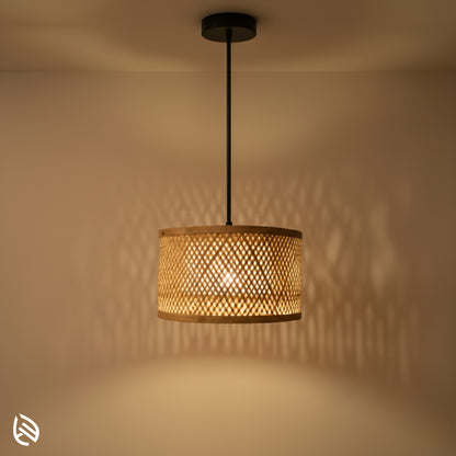 Minimal Nest bamboo drum pendant glowing; diamond lattice shade casting soft wall shadows, black canopy.