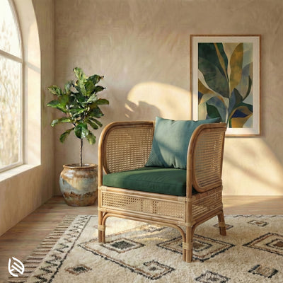 Wicker chair with cushions and a plant in a bright room with sunlight streaming in.