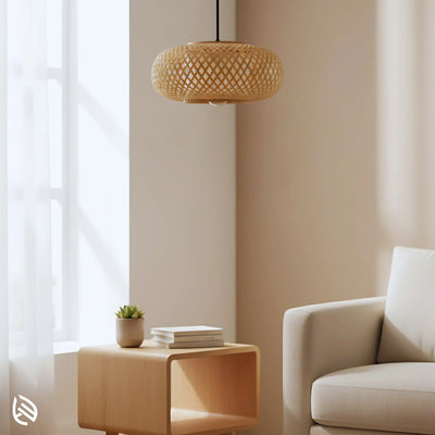 Oval Cage bamboo pendant styled in minimal living room near sofa and side table, soft daylight.