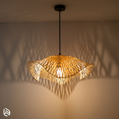 Radiance wave-edge bamboo pendant glowing; chevron lattice casts zig-zag wall shadows, black canopy.
