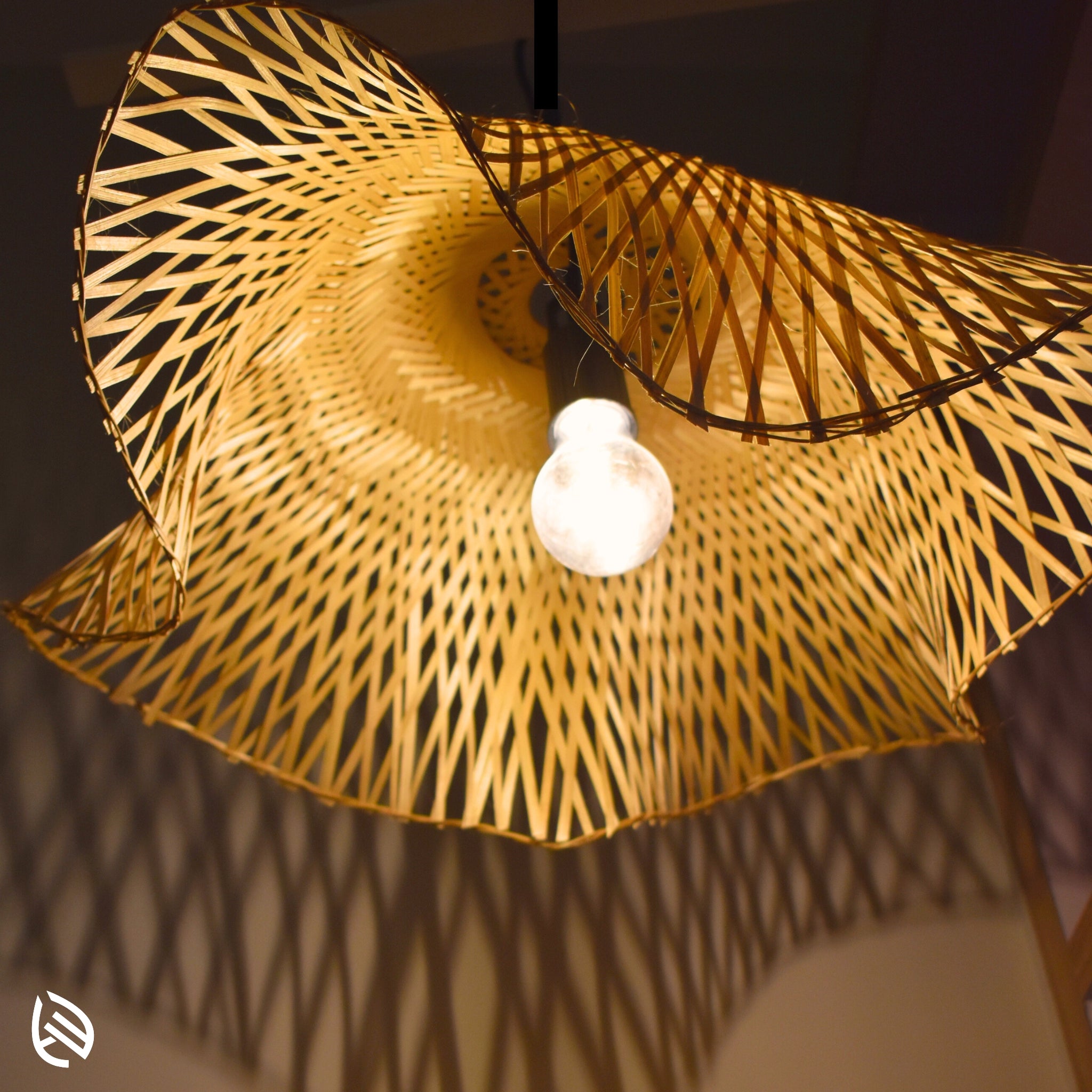 Underside close-up of Radiance pendant showing E27 bulb, ripple shade and cross-weave bamboo.