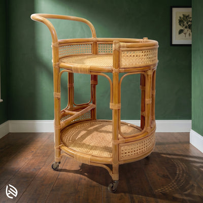 Wicker bar cart against a green wall
