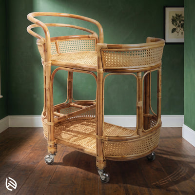 Wicker bar cart against a green wall