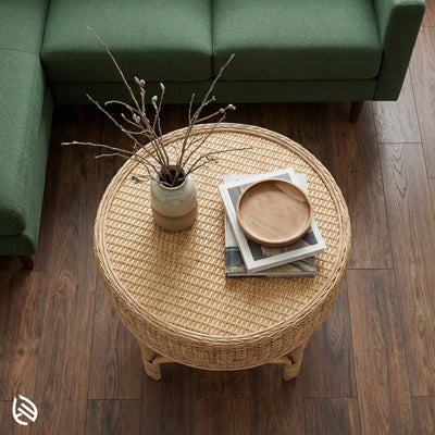 Wicker coffee table with decorative items in a living room setting